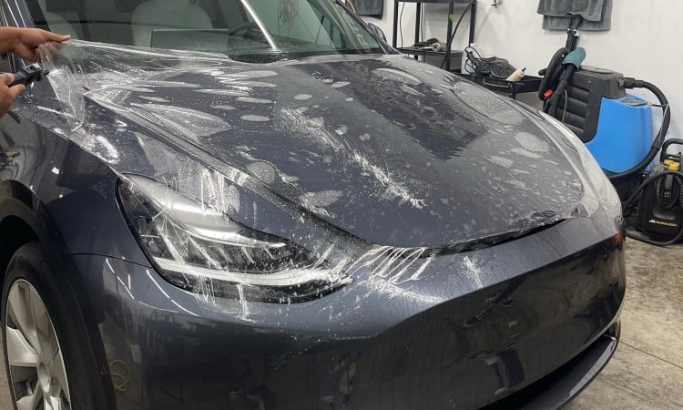 Tesla with Paint Protection Film being installed
